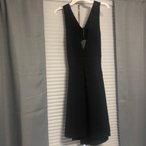 Mini black dress with deep V and semi open back